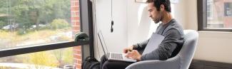 a student studies in an arm chair